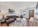 Stylish living room featuring a comfortable sofa, wood floors, and bright natural light at 714 Sedge Way, Lafayette, CO 80026