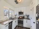 Modern kitchen with white cabinets, granite countertops, and stainless steel appliances at 2095 S Knox Ct, Denver, CO 80219