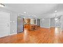 Open kitchen with island and stainless steel appliances at 3998 Haddon Rd, Denver, CO 80205