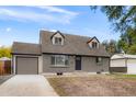 Newly remodeled home with gray exterior, featuring a modern door and attached garage at 9021 Raleigh St, Westminster, CO 80031