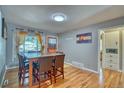 Bright dining room with a wood table, seating for six, and hardwood floors at 5610 Brentwood St, Arvada, CO 80002