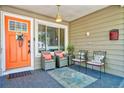 Inviting front porch with cozy seating, a stylish rug, and charming decor at 5610 Brentwood St, Arvada, CO 80002