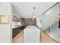 Open-concept kitchen with a marble island, pendant lighting, and modern appliances at 4426 Utica St, Denver, CO 80212
