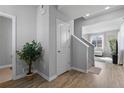 Bright entryway featuring hardwood floors, neutral walls, and a staircase leading to the upper level at 26818 E 1St Pl, Aurora, CO 80018