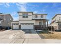 Inviting two-story home with a three-car garage and well-maintained lawn with stone accents at 26818 E 1St Pl, Aurora, CO 80018