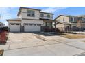 Charming two-story home with a three car garage, white siding, and stone accents at 26818 E 1St Pl, Aurora, CO 80018