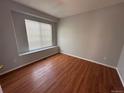 Well-lit bedroom with hardwood floors and large window at 20148 E Dartmouth Dr, Aurora, CO 80013