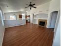 Open-concept living room with hardwood floors, fireplace, and view of kitchen at 20148 E Dartmouth Dr, Aurora, CO 80013