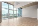 Bright living space with floor-to-ceiling windows showcasing city views and access to a balcony at 1700 Bassett St # 1102, Denver, CO 80202