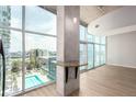 Bright living space with floor-to-ceiling windows showcasing city views and an in-wall bar at 1700 Bassett St # 1102, Denver, CO 80202