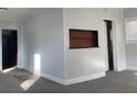 Bright living room with a niche detail, light walls, and carpeted floors at 4445 E Florida Ave, Denver, CO 80222