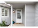 Inviting home entrance featuring a white door, charming address plate, and stylish accents at 11181 W Crestline Dr, Littleton, CO 80127