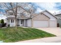 Charming two-story home featuring a three-car garage, well-maintained lawn, and inviting curb appeal at 11181 W Crestline Dr, Littleton, CO 80127