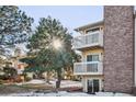 Building exterior showcasing balconies and winter landscaping at 12470 E Cornell Ave # 104, Aurora, CO 80014