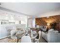 Inviting living space features a dining area, modern decor, and wood accent wall at 12470 E Cornell Ave # 104, Aurora, CO 80014