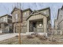 Attractive home featuring stone accents and a welcoming covered front porch, complemented by a neatly landscaped yard at 2616 Loon Cir, Castle Rock, CO 80104