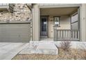 Inviting front porch and two-car garage showcasing stone accents and well-manicured landscaping at 2616 Loon Cir, Castle Rock, CO 80104