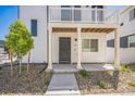 Inviting three-story home featuring a light exterior, well-kept yard, and welcoming architectural design at 18211 E 51St Ave, Denver, CO 80249