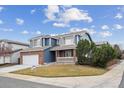 Charming two-story house with a blue exterior, a two-car garage, and a well-kept lawn at 10203 Jill Ave, Highlands Ranch, CO 80130