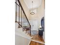 Foyer view with hardwood floors, staircase with wrought iron railings, and high ceilings with modern lighting at 10203 Jill Ave, Highlands Ranch, CO 80130