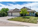 Inviting single-Gathering home with a lush lawn and a convenient three-car garage for ample parking at 1264 Banner Cir, Erie, CO 80516
