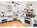Bright kitchen featuring white cabinets, stainless steel appliances, and red countertops on wood floor at 1439 S Emerson St, Denver, CO 80210