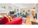 Cozy living room with hardwood floors, bright couches, and an open floor plan at 1439 S Emerson St, Denver, CO 80210