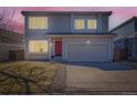 Charming two-story home with a red front door and well-maintained lawn in a residential neighborhood at 4774 Waldenwood Dr, Highlands Ranch, CO 80130