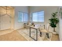 Inviting office area with ample natural light, a modern desk setup, and stylish chair near the entry at 7345 S Nucla St, Aurora, CO 80016