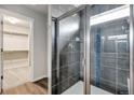 Modern shower with glass door, tiled walls and floor, and a walk-in closet at 782 Griffith St, Lochbuie, CO 80603