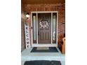 Inviting front door with decorative wreath, sidelights, and 'Welcome' sign at 5405 S Sicily St, Aurora, CO 80015
