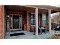 Inviting front porch with brick accents, decorative seating, and a welcoming ambiance at 5405 S Sicily St, Aurora, CO 80015