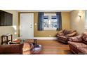 Cozy living room featuring hardwood floors and comfortable leather seating at 141 N 5Th Ave, Brighton, CO 80601