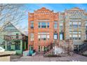 Charming three-story brick townhome with a stone front porch and beautiful architectural details at 1610 N Humboldt St # 1/2, Denver, CO 80218