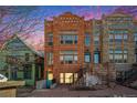 Three-story brick townhome with intricate architectural details at 1610 N Humboldt St # 1/2, Denver, CO 80218