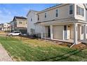 Townhome showcasing the well-maintained front lawn, driveway, and appealing facade at 27492 E 1St Ave, Aurora, CO 80018