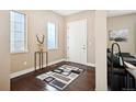 Open entryway featuring hardwood floors, neutral paint, and easy access to the living area at 15569 W La Salle Ave, Lakewood, CO 80228