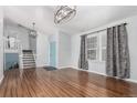 Bright living room with hardwood floors, modern lighting, and a staircase at 2014 S Pagosa St, Aurora, CO 80013