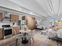 Open living space with a well-equipped kitchen, dining area, cozy living space, and a comfortable sleeping area at 1495 Vrain St # 214, Denver, CO 80204