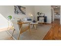 Bright living room with modern furnishings, hardwood floors, and an artful painting at 2850 Lowell Blvd, Denver, CO 80211