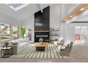 Virtually staged living room with a modern fireplace and large windows at 8704 Garrison Ct, Arvada, CO 80005