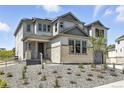 Charming two-story home with a covered front porch and rock landscaping in the front yard at 1694 Fox Trotter Pt, Castle Rock, CO 80104