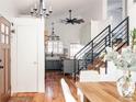 Sun-filled living room with wood floors and staircase leading to the upper level at 2719 S Truckee St, Aurora, CO 80013