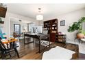 Spacious home office with hardwood floors, a large desk, and built-in shelving at 7142 S Hudson Ln, Centennial, CO 80122