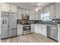Bright kitchen with white cabinetry, stainless steel appliances, and attractive backsplash at 1135 S Gilbert St # 103, Castle Rock, CO 80104