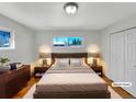 Cozy bedroom with hardwood floors, large window and neutral decor at 7180 Zuni St, Denver, CO 80221