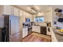 Efficient kitchen with white cabinets, stainless steel appliances, and granite countertops at 5757 S Algonquian Way # E, Aurora, CO 80016