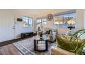 Inviting living room featuring large windows, neutral decor, and stylish furnishings at 5757 S Algonquian Way # E, Aurora, CO 80016