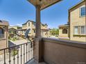 Balcony view showing neighboring townhomes under a bright blue sky at 10578 Parkington Ln # 35D, Highlands Ranch, CO 80126