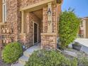 Inviting front entrance with brick facade, manicured landscaping, and clearly visible address numbers at 10578 Parkington Ln # 35D, Highlands Ranch, CO 80126